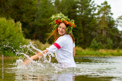Fototapeta Naklejka Na Ścianę i Meble -  Pretty girl in national dress is in water