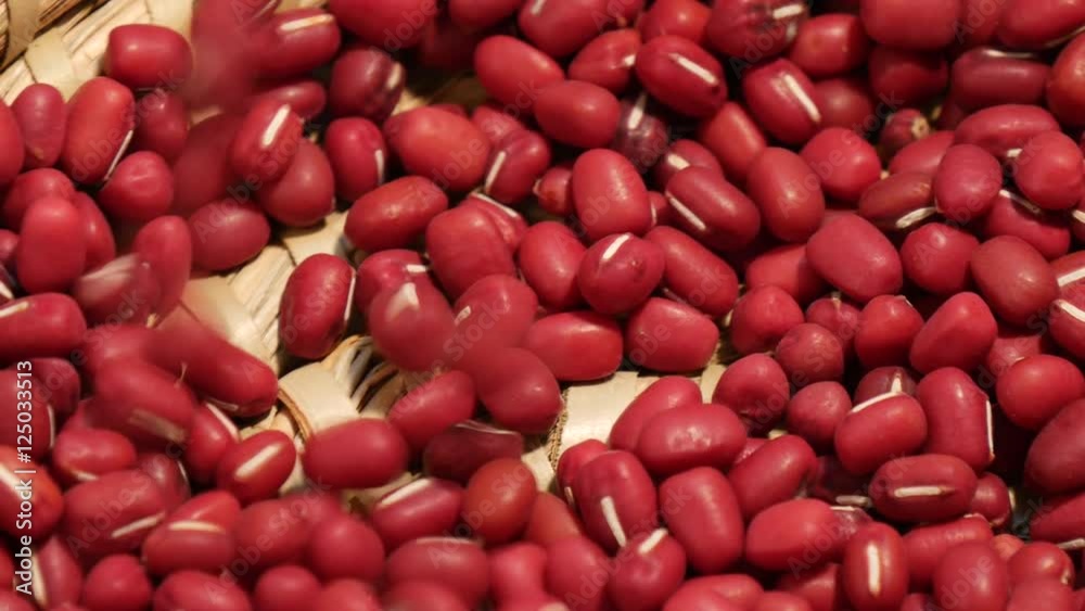 Falling red adzuki beans into turning basket
Falling red adzuki beans into turning basket