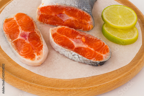 Three Piece of raw salmon and two slices of lemon