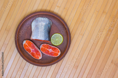 Sliced salmon and a slice of lemon