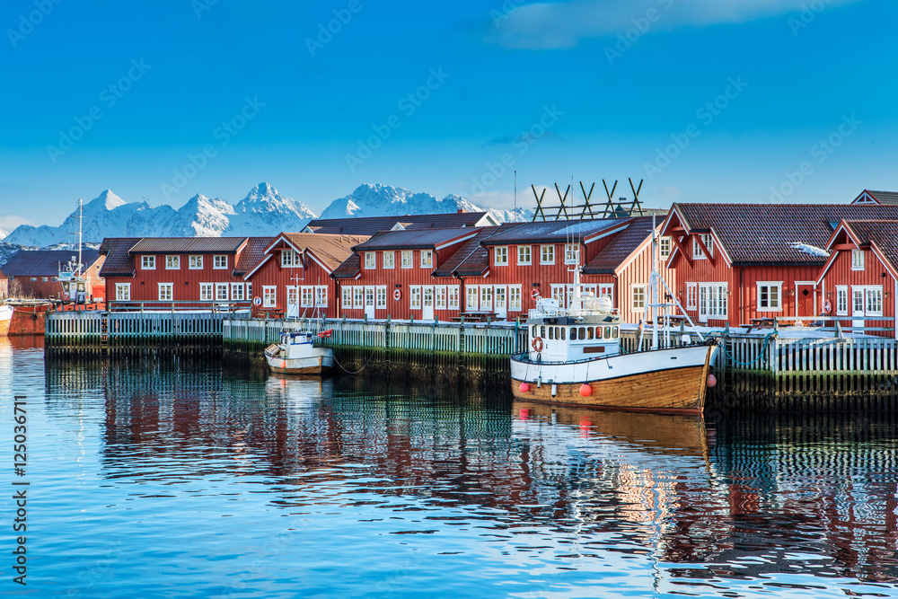 Typical red harbor houses in Svolvaer at early morning. Svolvaer is located in Nordland County on the island of Austvagoya.