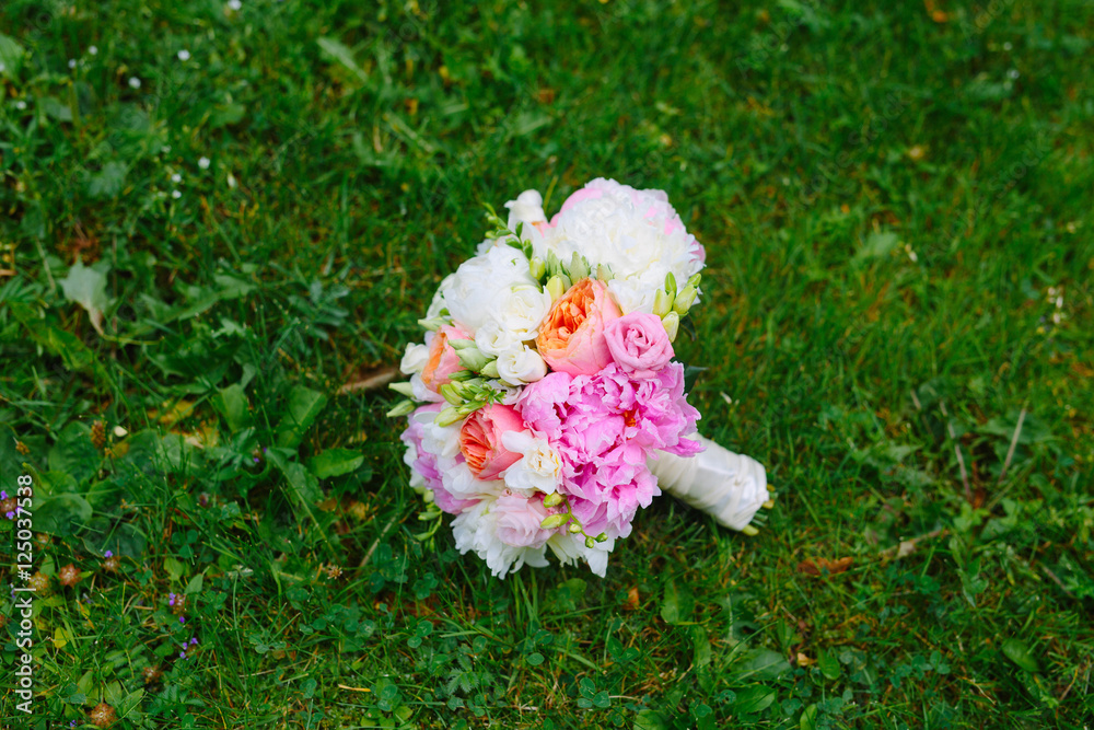 Bouquet of peonies the bride on the grass Bouquet of peonies the bride on the grass