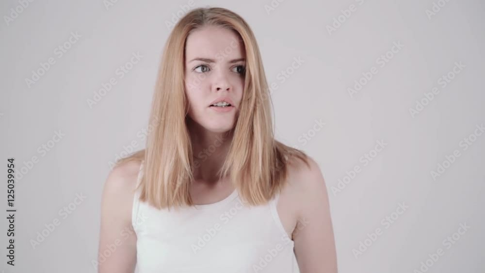 Young woman showing several emotion expressions, isolated on light grey background. Properly color corrected version Young woman showing several emotion expressions, isolated on light grey background. Properly color corrected version