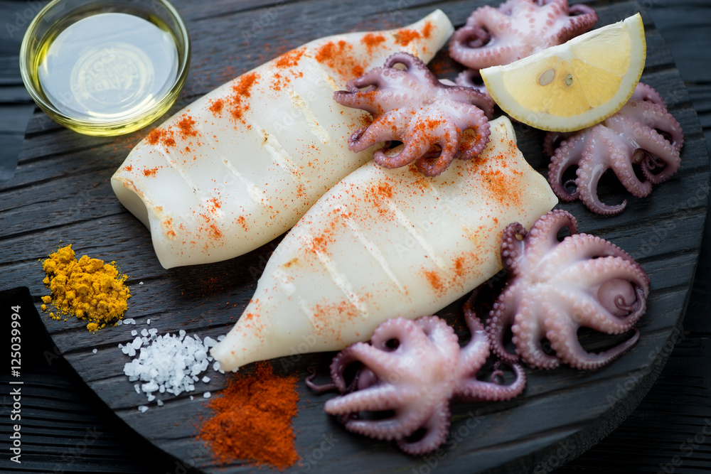 Grilled calamari, pickled baby octopuses and spices, close-up Grilled calamari, pickled baby octopuses and spices, close-up