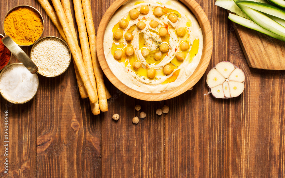 Hummus on a wooden background, soft focus, horizontal, top view Hummus on a wooden background, soft focus, horizontal, top view