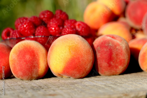 good juicy ripe fruits plate raspberries and peaches.