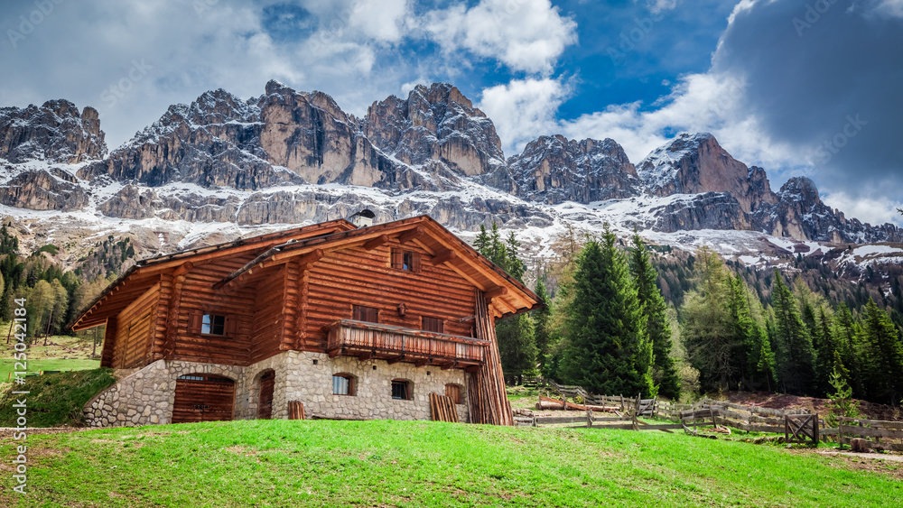 Wooden cottage in the Dolomites in the spring, Italy