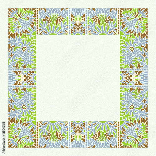 Paper napkin with an ornament on edges. Blue flowers and green leaves. Cut out
colored pieces. Mosaic pattern in vintage style.
