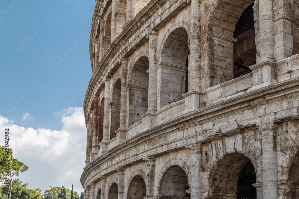 The Colosseum, an architectural monument in Rome, the fragment of the wall against the sky