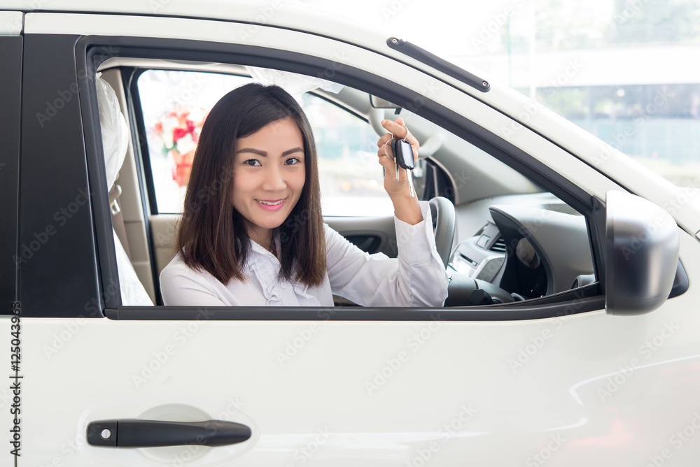 Young Happy Woman Showing The Key Of her New Car, Dream comes tr Young Happy Woman Showing The Key Of her New Car, Dream comes tr