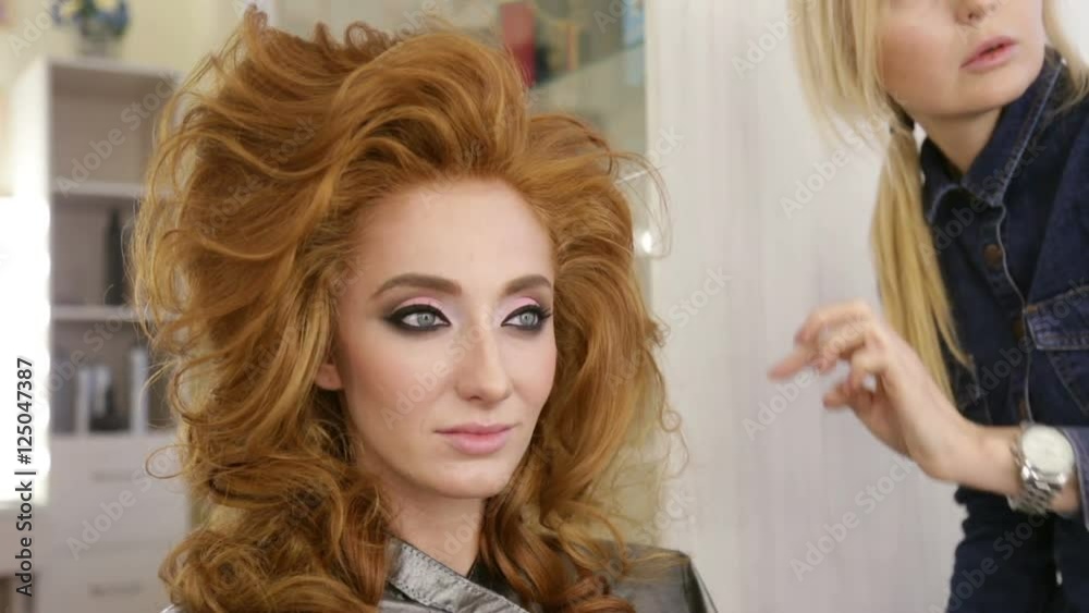 Professional Stylist makes hairstyle girl. Professional Stylist makes hairstyle girl.
