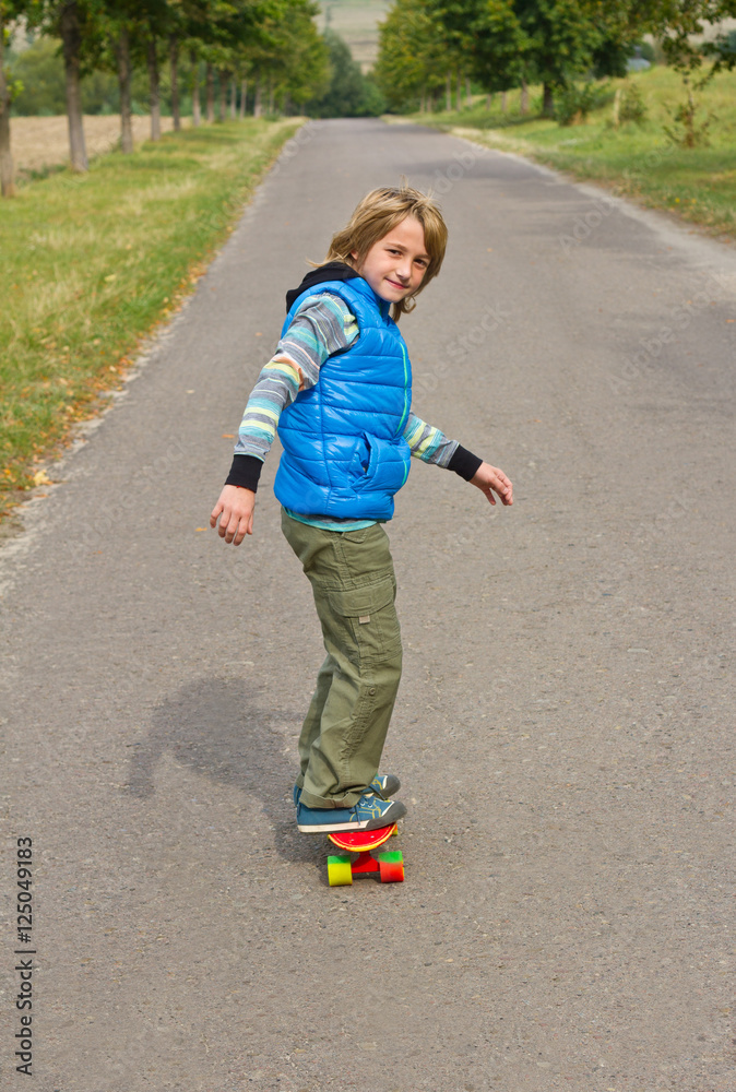 little boy having fun with skateboard outdoors. little boy having fun with skateboard outdoors.