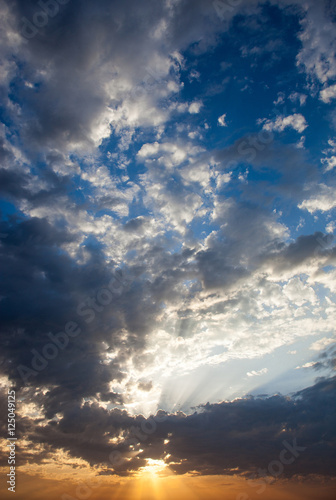 Cloudscape with the sun rays radiating from behind the cloud