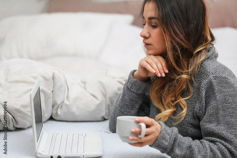 Girl in bed with a Cup and computer Girl in bed with a Cup and computer