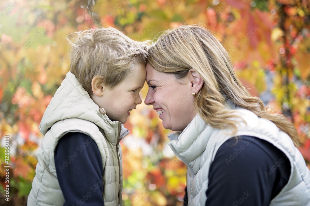 Mother with the child in autumn season Mother with the child in autumn season
