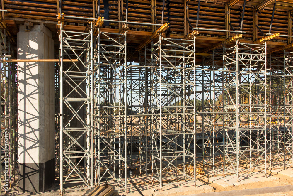 .construction scaffolding built under an overpass over the highw .construction scaffolding built under an overpass over the highw