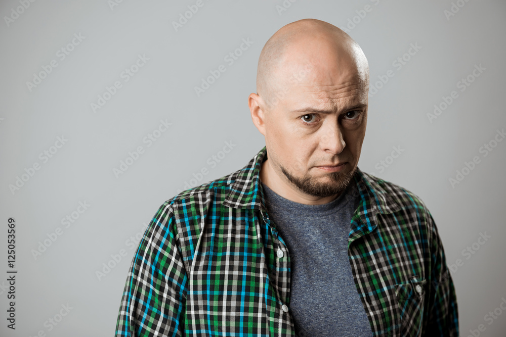 Portrait of resentful sad emotive man over beige background. Portrait of resentful sad emotive man over beige background.