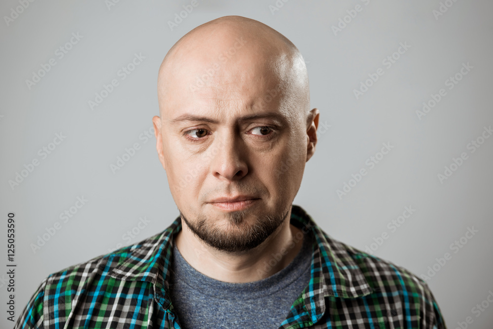 Portrait of upset handsome man thinking over beige background. Portrait of upset handsome man thinking over beige background.