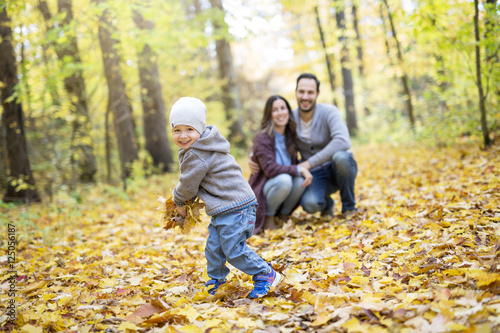 Happy family relaxing outdoors In autumn park