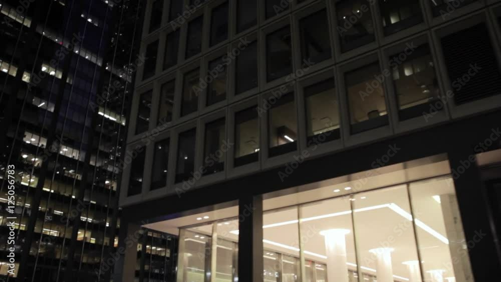 Pan low angle aerial shot of skyscrapers in NYC New York City Manhattan night street Pan low angle aerial shot of skyscrapers in NYC New York City Manhattan night street