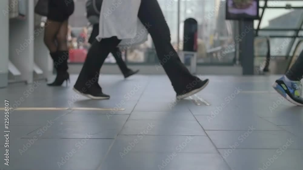 People walking in train station with baggage luggage going on travel or business trip. Mostly out of focus and blurry. Transport concept with feet and and legs. Slow motion footage People walking in train station with baggage luggage going on travel or business trip. Mostly out of focus and blurry. Transport concept with feet and and legs. Slow motion footage