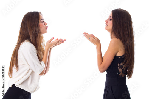 Two women sending air kisses 