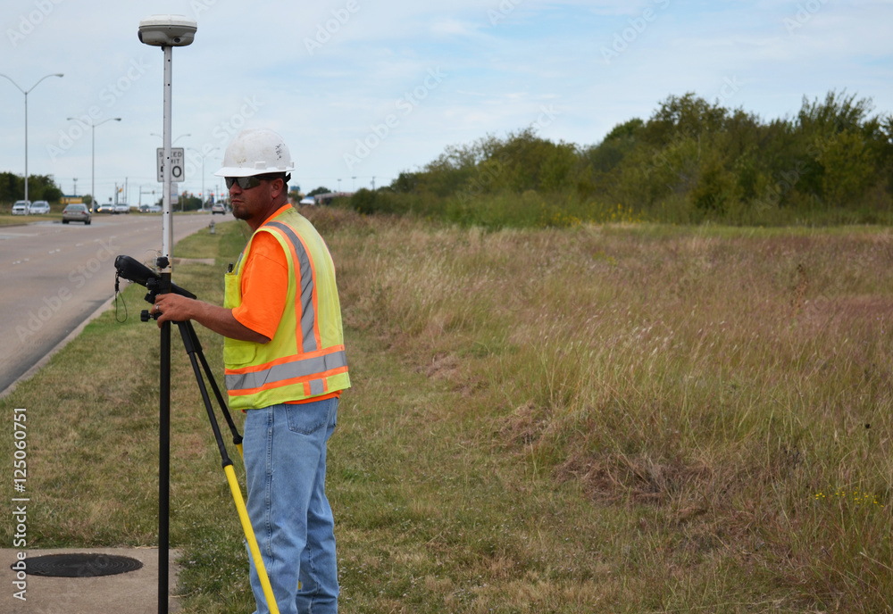 Land Surveyor In Safety Gear Using Equipmemt Land Surveyor In Safety Gear Using Equipmemt