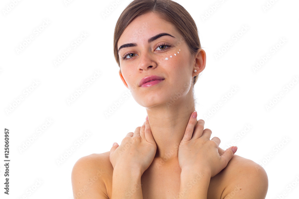 Young woman with ponytail and dots of cream on her face Young woman with ponytail and dots of cream on her face