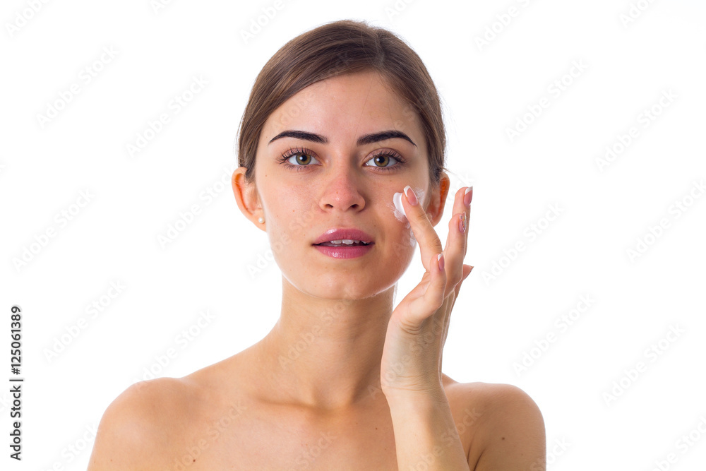 Young woman using cream