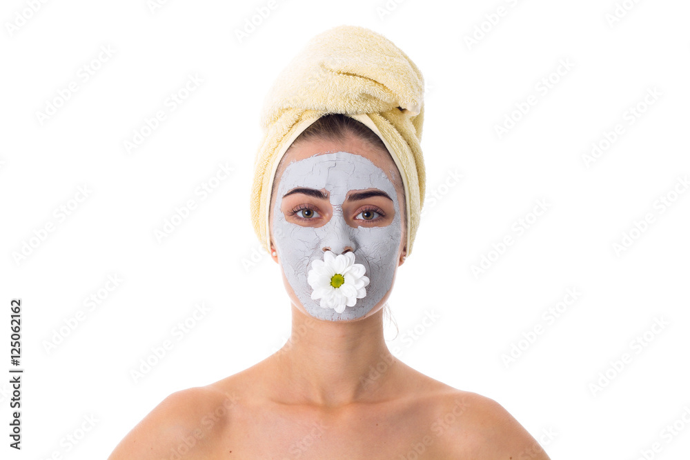 Woman with towel on her head and cosmetic mask on her face Woman with towel on her head and cosmetic mask on her face