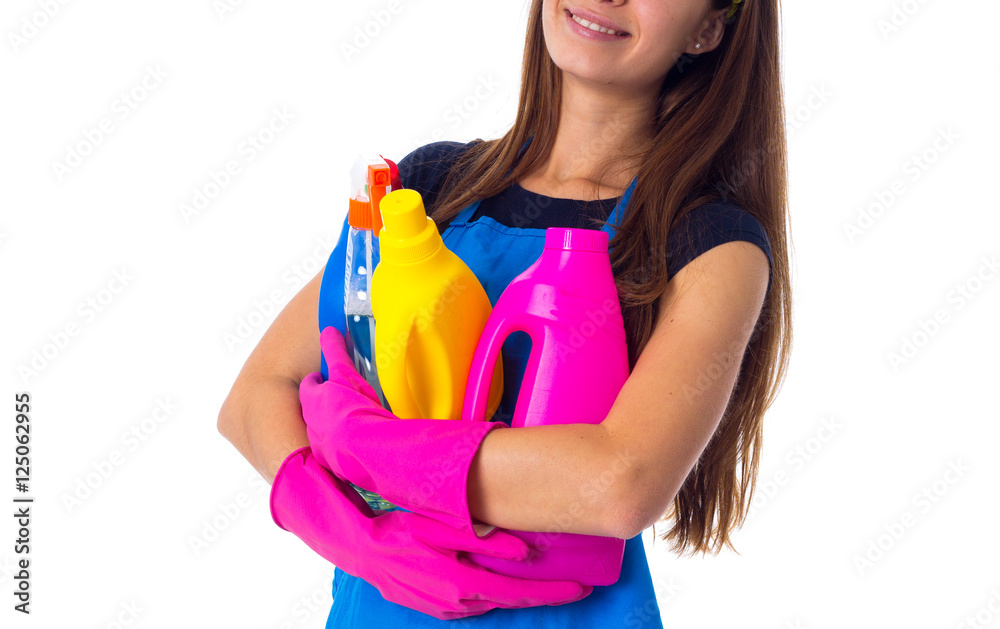 Woman in apron holding a detergents Woman in apron holding a detergents
