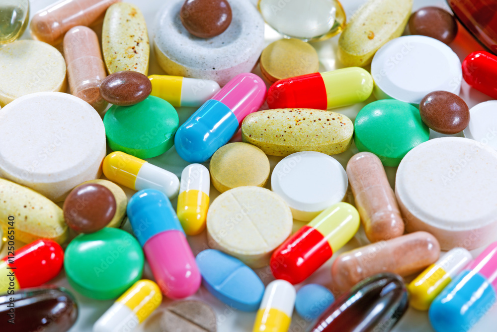 Vitamins, omega 3, cod-liver oil, dietary supplement and tablets an embankment on a light background close up, the top view Vitamins, omega 3, cod-liver oil, dietary supplement and tablets an embankment on a light background close up, the top view