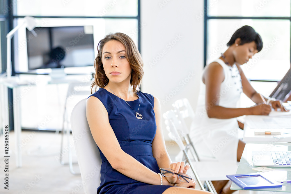 Young businesswoman sitting at desk and working Young businesswoman sitting at desk and working