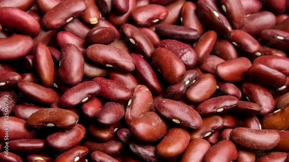 Macro close up of raw organic red kidney beans being scooped up by a wooden spoon, 4K 30p Macro close up of raw organic red kidney beans being scooped up by a wooden spoon, 4K 30p