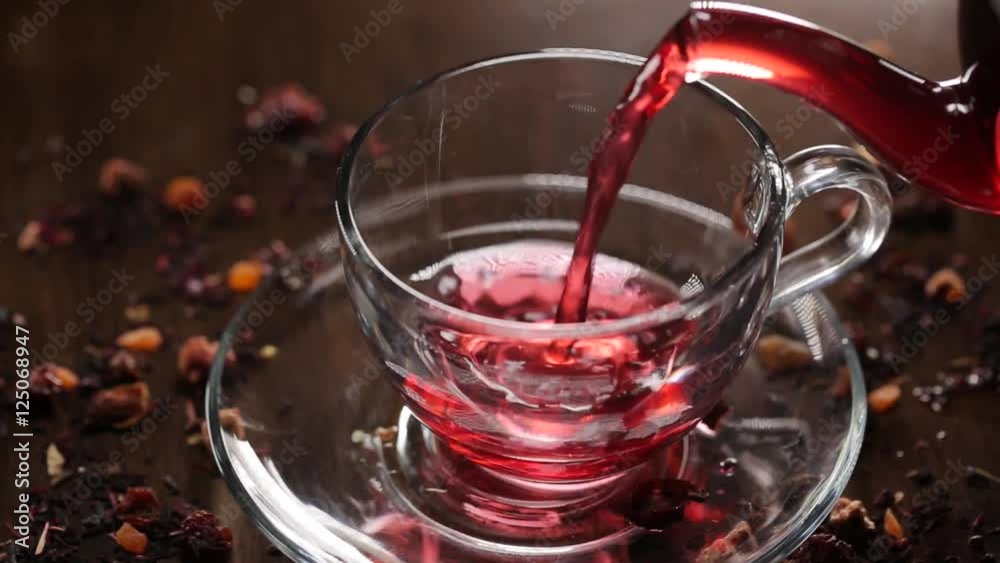 Hibiscus tea pouring into transparent glass