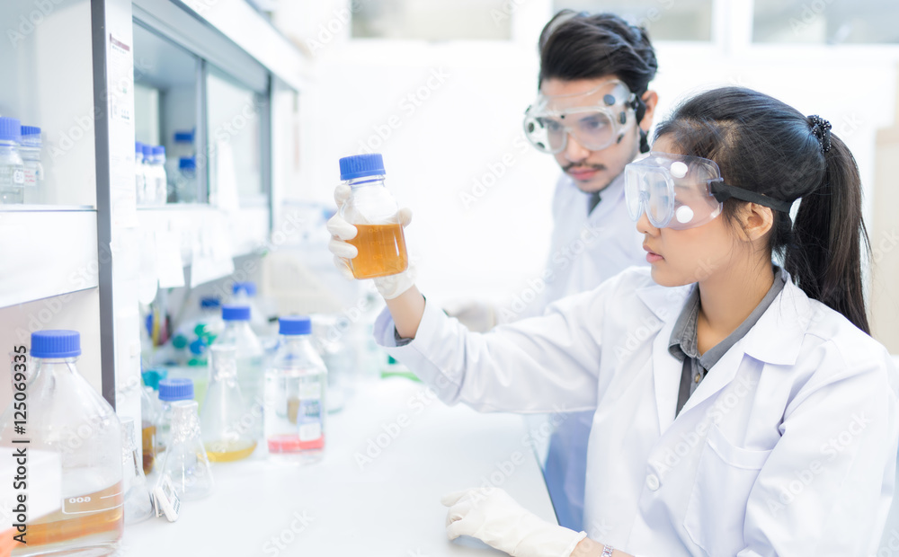 Asian scientist in the laboratory working at lab with test tube Asian scientist in the laboratory working at lab with test tube