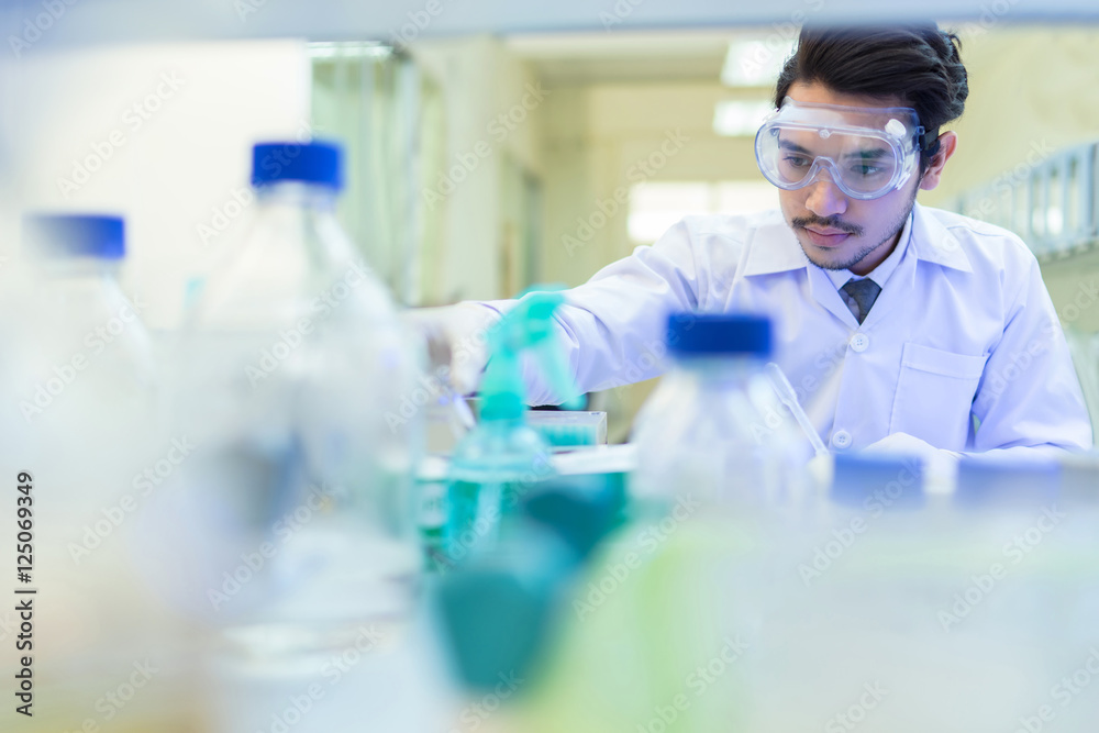 Asian scientist in the laboratory working at lab with test tube Asian scientist in the laboratory working at lab with test tube