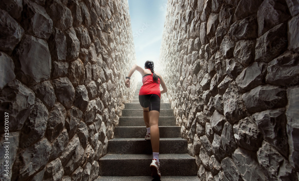 Αυτοκόλλητο Women are exercising by running up the stairs.