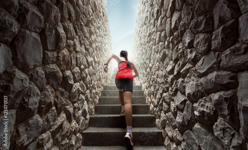 Women are exercising by running up the stairs.