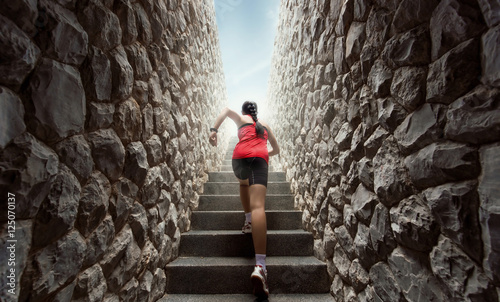 Women are exercising by running up the stairs.