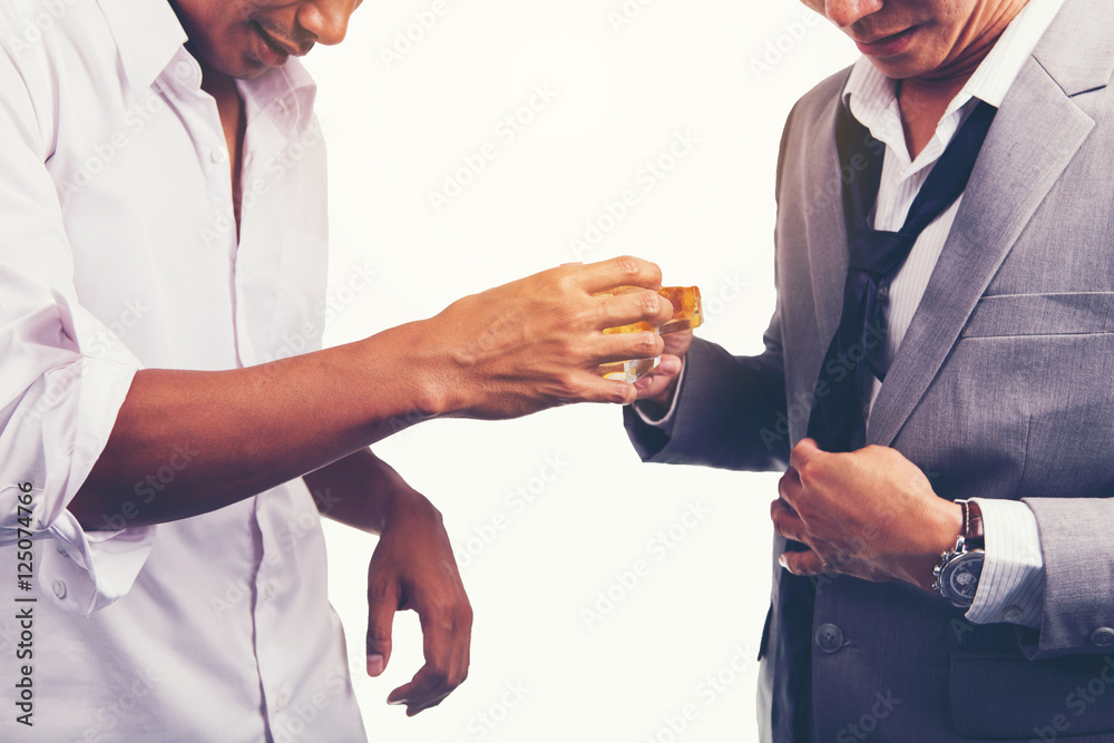 Two businessman in shirt and tie talking to each other while drinking whisky after office hour.