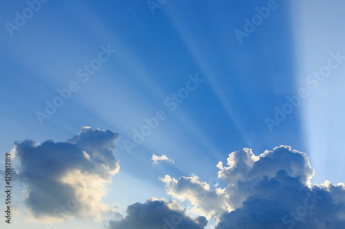 light rays explosion on clear blue sky with cloud
