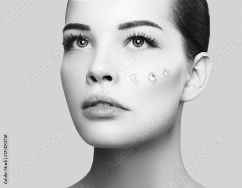 Fashion beautiful woman with drops of gel on another cheek photo