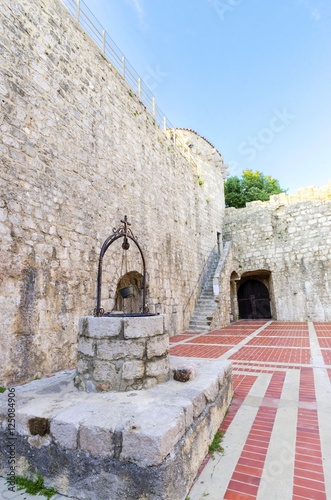 The interior of the Frankopan Castle at Kamplin square in Krk, Croatia - Frankopanski Kastel, part of medieval city walls. View of the courtroom, the well, stern, square tower and archer loop holes.