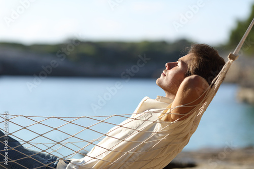 Man relaxing on a hammock in the beach #125085975
