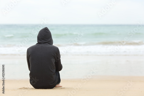 Teenager boy thinking watching the sea