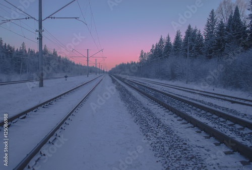 Frozen railway road to the twilight