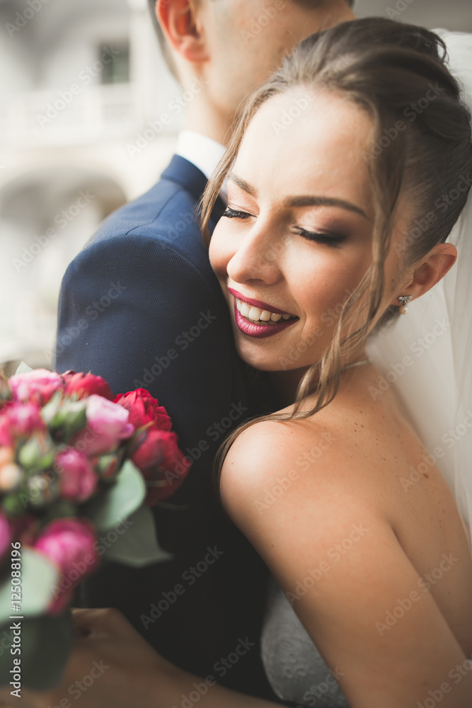 Portrait of happy newly wedding couple with bouquet Portrait of happy newly wedding couple with bouquet