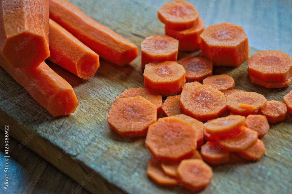 Whole and chopped carrots on a cutting board Whole and chopped carrots on a cutting board
