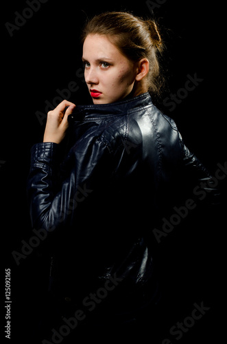a young girl in a leather jacket